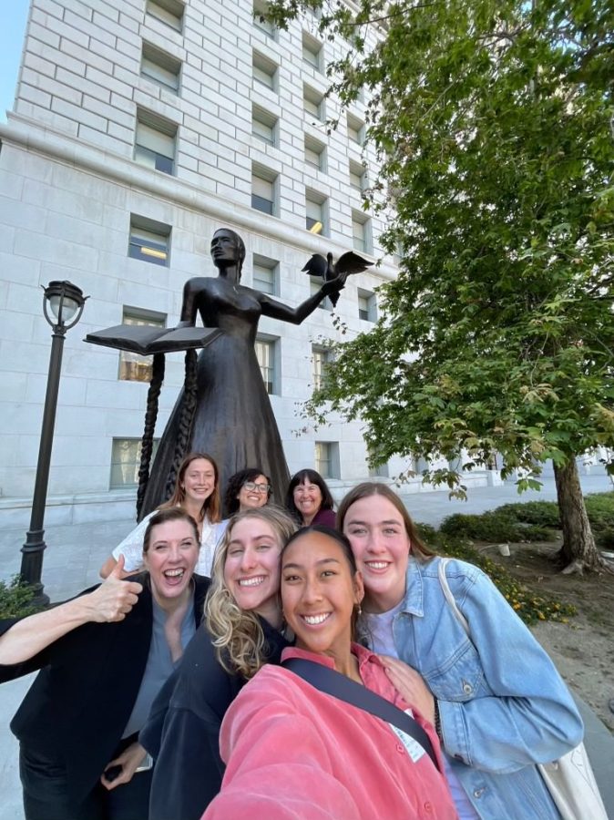 The UI Los Angeles group stands with Mary Glenn (back right) in front of the EMBODIED statue at the Los Angeles County Hall of Justice.